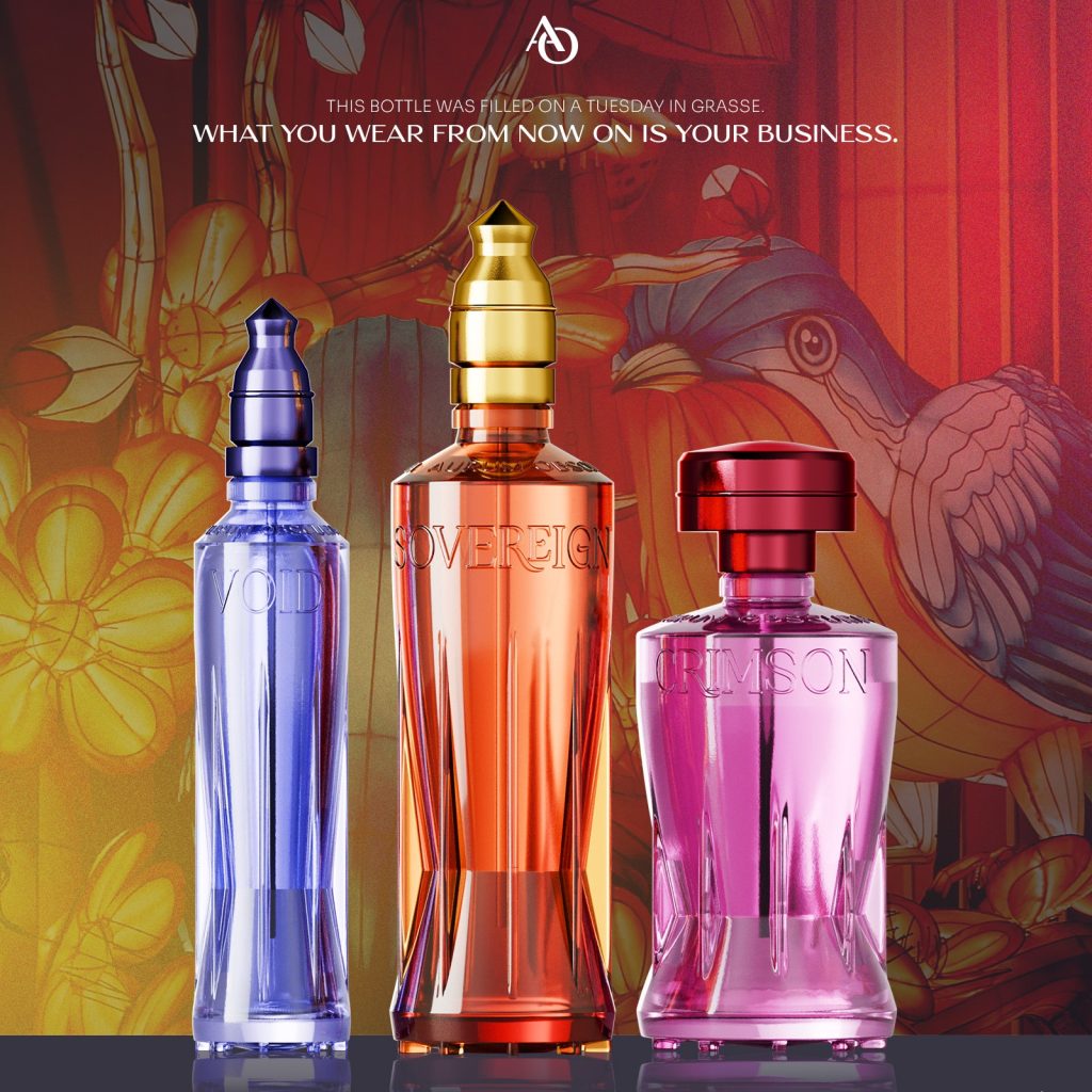 AURUM OBSCURA editorial campaign poster featuring VOID, SOVEREIGN, and CRIMSON bottles against a warm botanical illustration background with headline — This bottle was filled on a Tuesday in Grasse. What you wear from now on is your business. Tagline Worn in Shadow. Carried into Light.